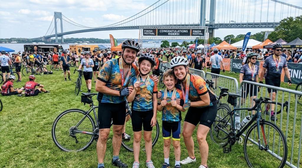 Smiling family celebrating at the Finish Festival on Staten Island after the ride