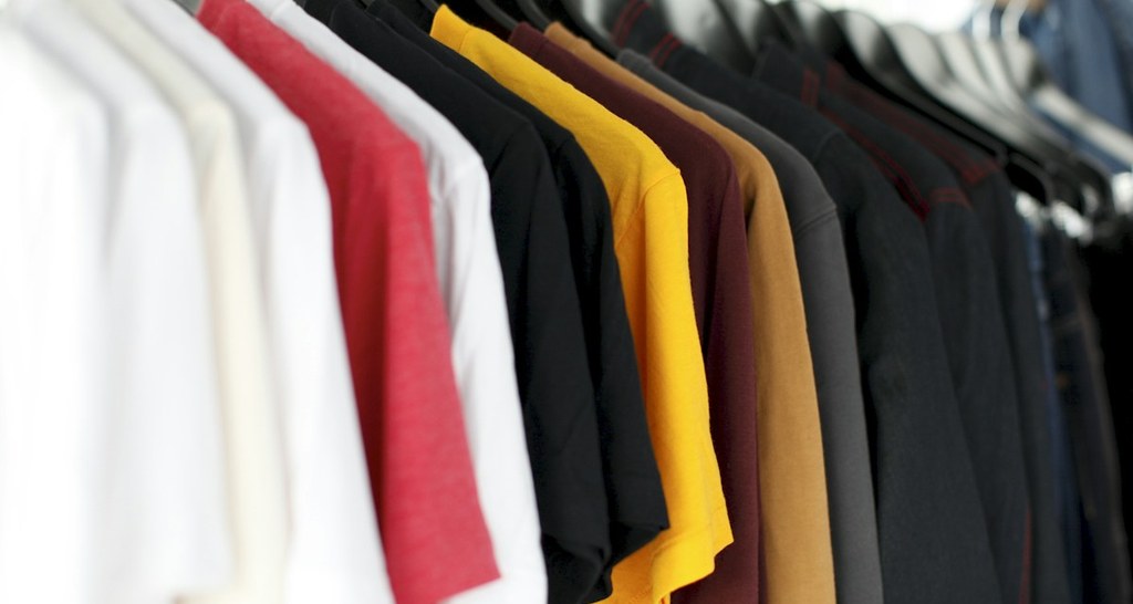 Flatlay of recommended winter clothing layers for visiting Rockefeller Center Christmas tree in December